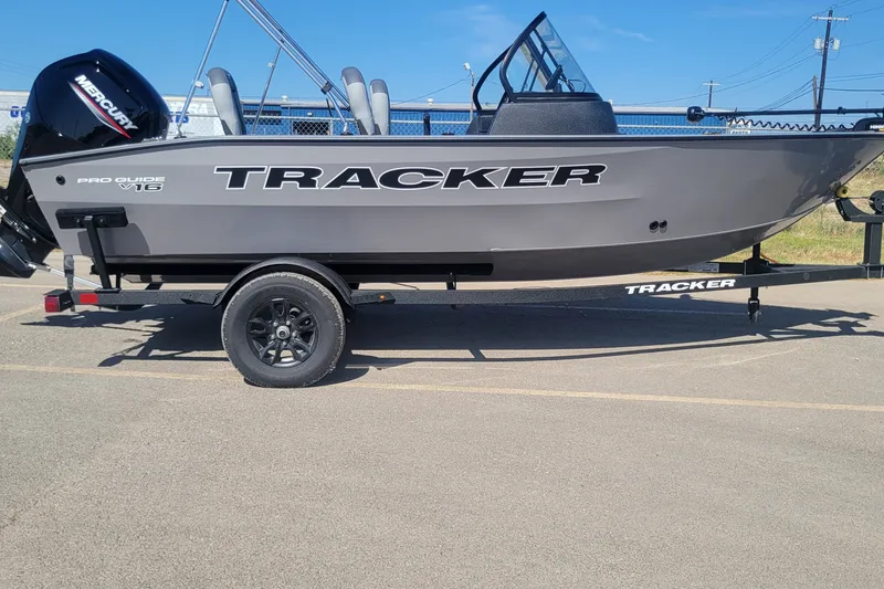 The Image of 2027 Tracker Pro Guide V-16 WT boat on trailer, featuring sleek design and Mercury engine. - 0