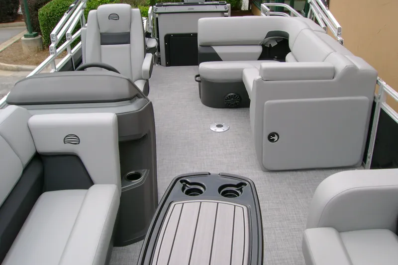 Slide: The Image of 2027 Sun Tracker SportFish 22 DLX pontoon boat interior with gray seating and table. - 12