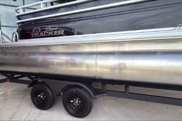 The Image of 2027 Sun Tracker SportFish 22 DLX pontoon boat on trailer, side view. - 0