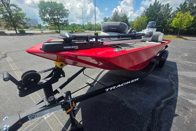 The Image of 2027 Tracker Pro 170 boat with Minn Kota motor on trailer in parking lot. - 0