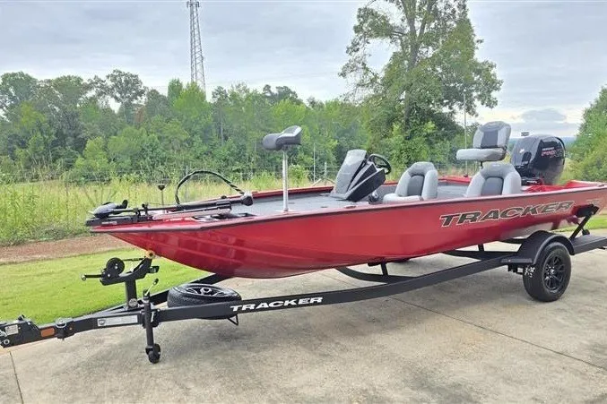 Slide: The Image of Red 2027 Tracker Pro Team 195 boat on trailer, parked outdoors. - 39