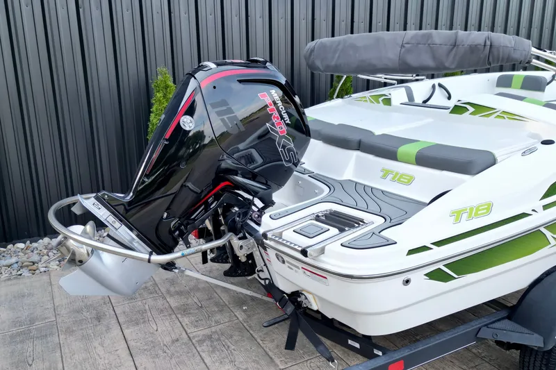 Slide: The Image of 2022 Tahoe T18 boat with Mercury outboard motor, docked on wooden platform. - 3