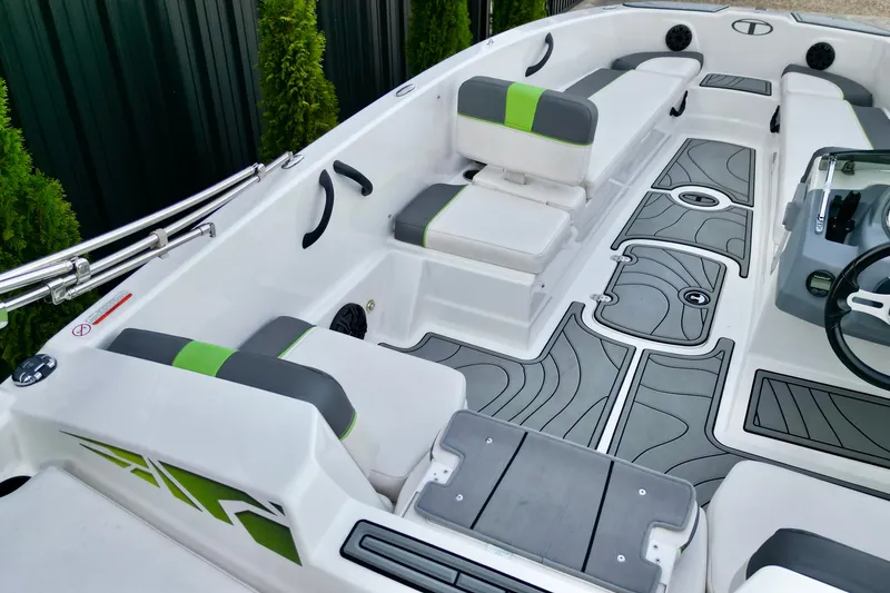 Slide: The Image of 2022 Tahoe T18 boat interior with gray and green seating, modern design. - 4