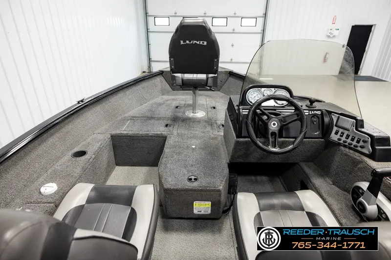 Slide: The Image of 2017 Lund 1650 Rebel XS SS boat interior with steering console and seating. - 12