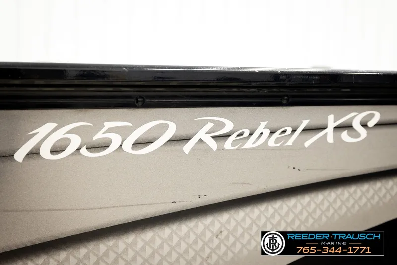 Slide: The Image of 2017 Lund 1650 Rebel XS SS boat side view with branding and dealership logo. - 44