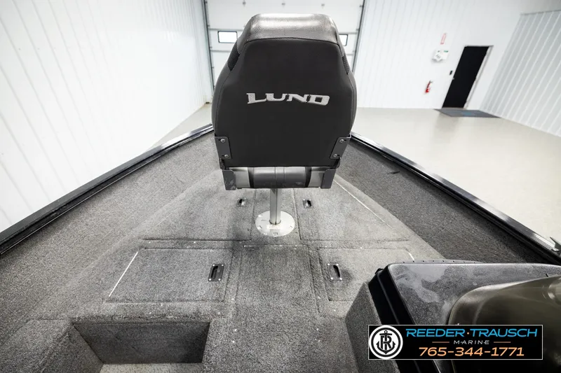 Slide: The Image of 2017 Lund 1650 Rebel XS SS boat interior with seating and storage compartments. - 24