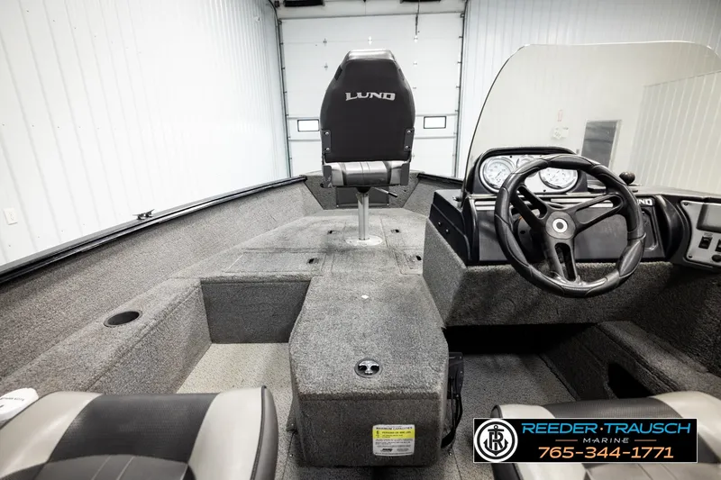 Slide: The Image of 2017 Lund 1650 Rebel XS SS boat interior with steering wheel and seating. - 22