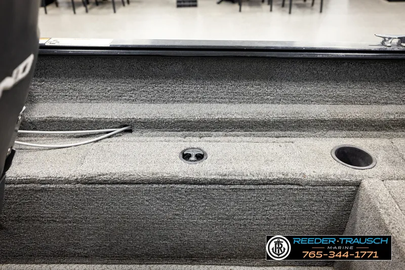 Slide: The Image of 2017 Lund 1650 Rebel XS SS boat interior with carpeted flooring and storage compartments. - 18