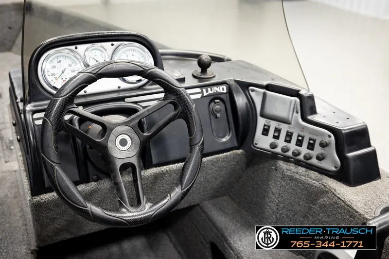Slide: The Image of 2017 Lund 1650 Rebel XS SS boat dashboard with steering wheel and control panel. - 27