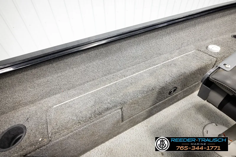 Slide: The Image of 2017 Lund 1650 Rebel XS SS boat interior with carpeted storage and seating. - 20