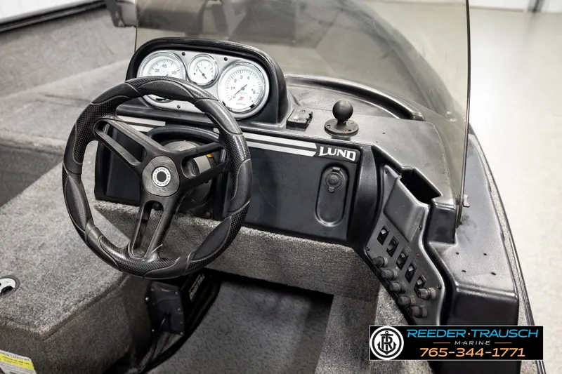 Slide: The Image of 2017 Lund 1650 Rebel XS SS boat dashboard with steering wheel and control panel. - 26