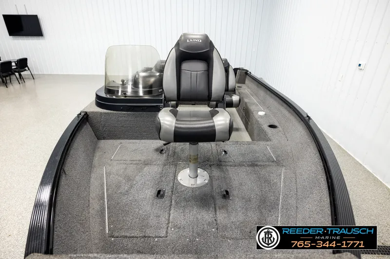 Slide: The Image of 2017 Lund 1650 Rebel XS SS boat interior with seating and console, displayed indoors. - 14