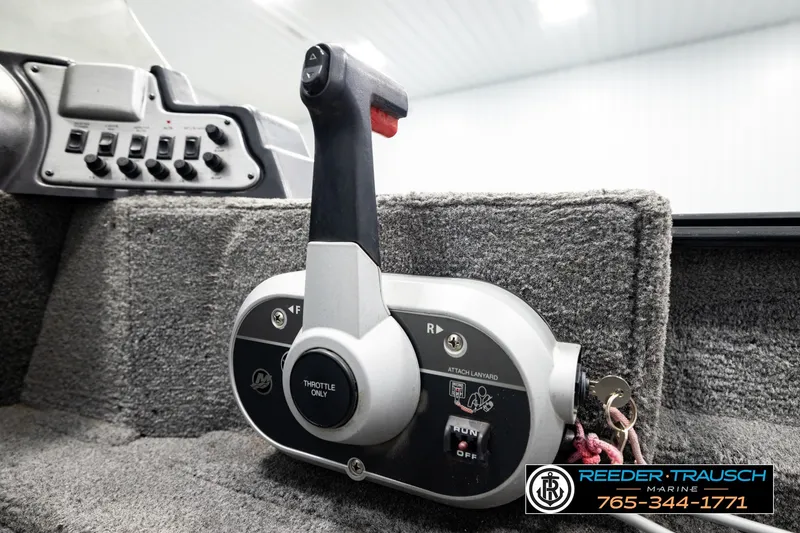 Slide: The Image of Throttle control of 2017 Lund 1650 Rebel XS SS boat, featuring control panel and lanyard attachment. - 32