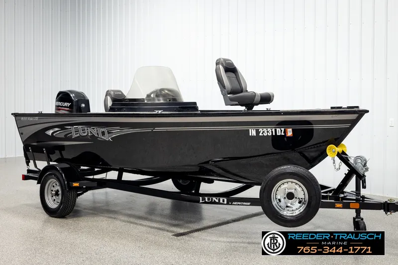 Slide: The Image of 2017 Lund 1650 Rebel XS SS fishing boat on trailer, featuring Mercury outboard motor. - 2
