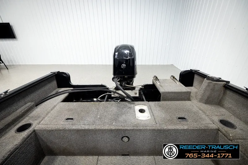 Slide: The Image of 2017 Lund 1650 Rebel XS SS boat interior with motor, displayed in showroom. - 16