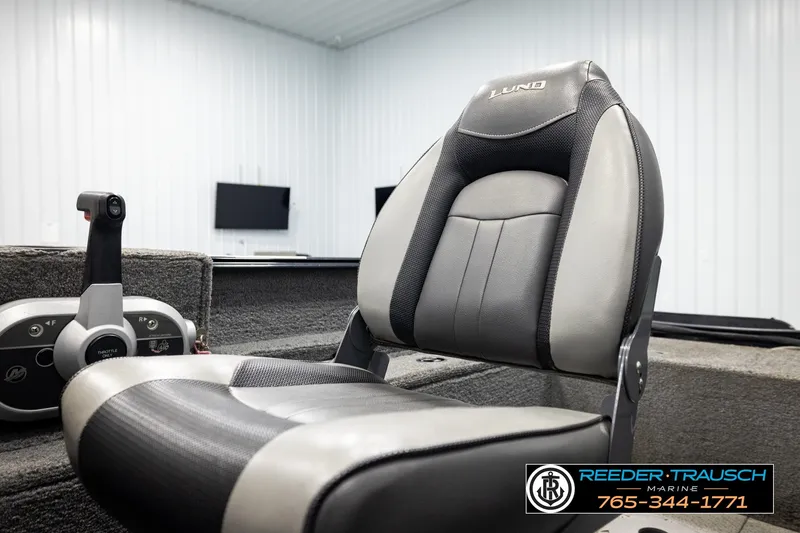 Slide: The Image of 2017 Lund 1650 Rebel XS SS boat seat and throttle control in a showroom. - 33