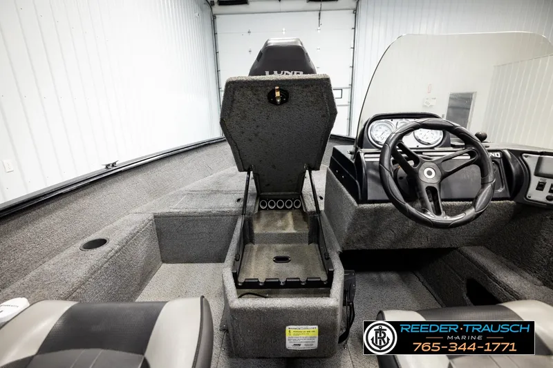Slide: The Image of 2017 Lund 1650 Rebel XS SS boat interior with steering wheel and storage compartment. - 23