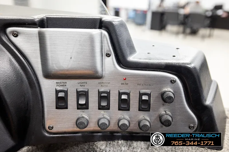 Slide: The Image of Control panel of a 2017 Lund 1650 Rebel XS SS boat with switches and knobs. - 31