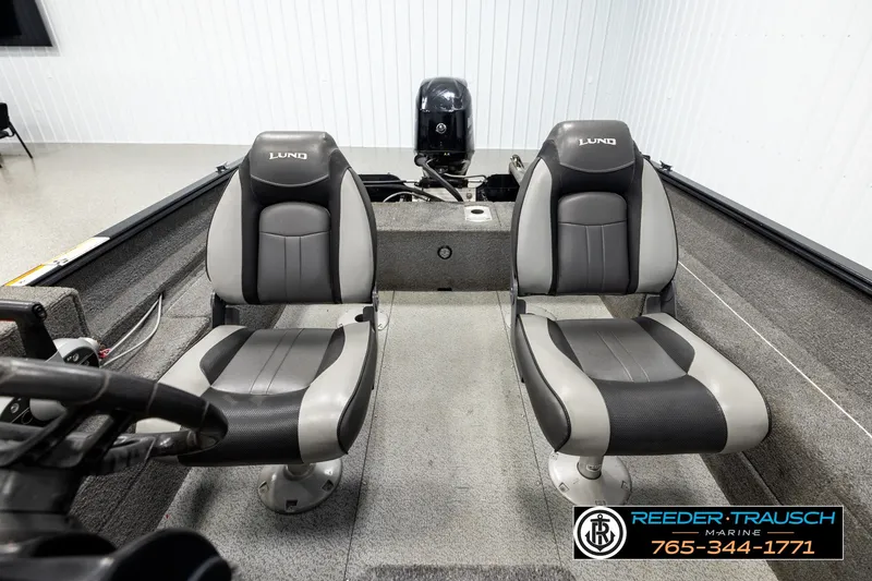 Slide: The Image of 2017 Lund 1650 Rebel XS SS boat interior with two gray seats and steering wheel. - 15