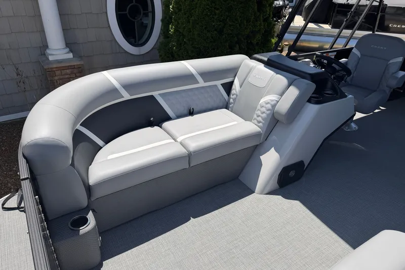 Slide: The Image of 2025 Crest Classic 200 pontoon boat interior with gray seating and modern helm. - 6
