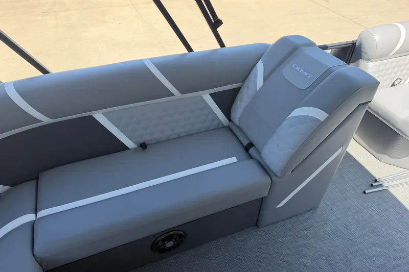 Slide: The Image of 2025 Crest Classic 200 boat interior with gray cushioned seating and modern design. - 15