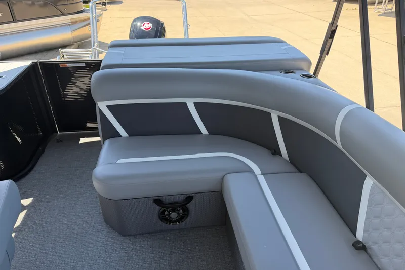 Slide: The Image of Interior of 2025 Crest Classic 200 pontoon boat with gray seating and cup holders. - 8
