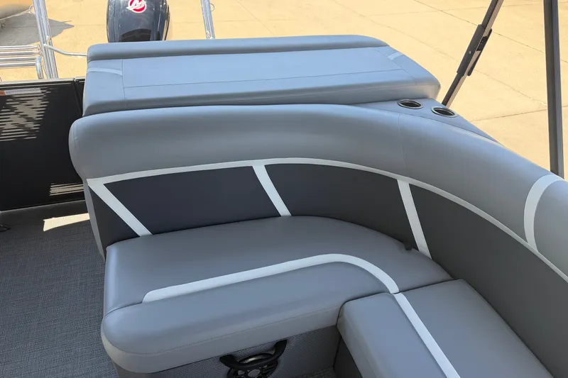 Slide: The Image of 2025 Crest Classic 200 boat interior with gray cushioned seating and cup holders. - 16