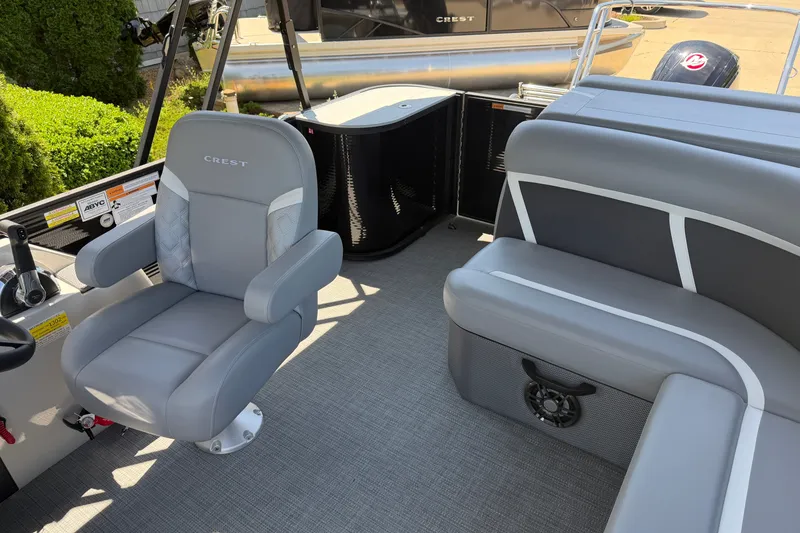 Slide: The Image of Interior of 2025 Crest Classic 200 boat with gray seating and steering console. - 9