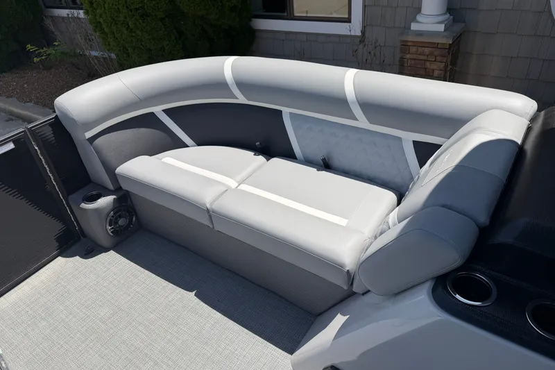 Slide: The Image of Luxurious seating on 2025 Crest Classic 200 pontoon boat, featuring sleek gray upholstery. - 14