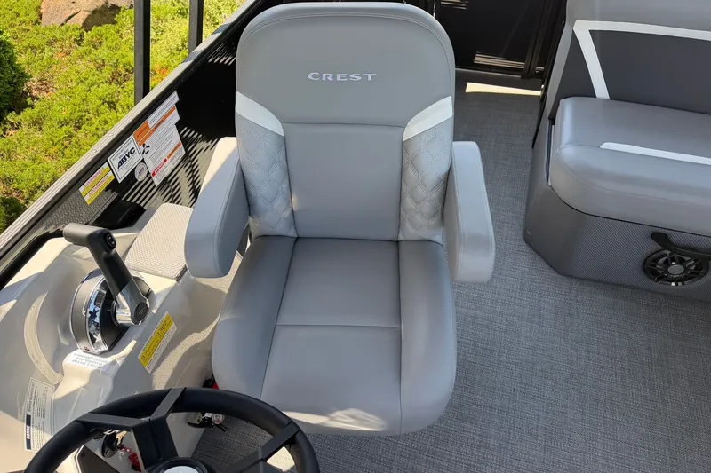Slide: The Image of Captain's chair on 2025 Crest Classic 200 boat, featuring sleek design and controls. - 11
