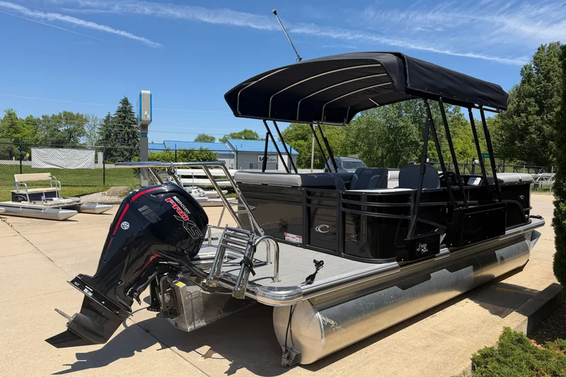 Slide: The Image of 2025 Crest Classic 200 pontoon boat with canopy and outboard motor on display. - 19