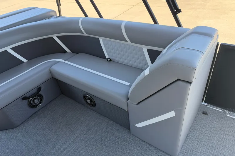 Slide: The Image of Luxurious seating on 2025 Crest Classic 200 pontoon boat, featuring sleek gray upholstery. - 7