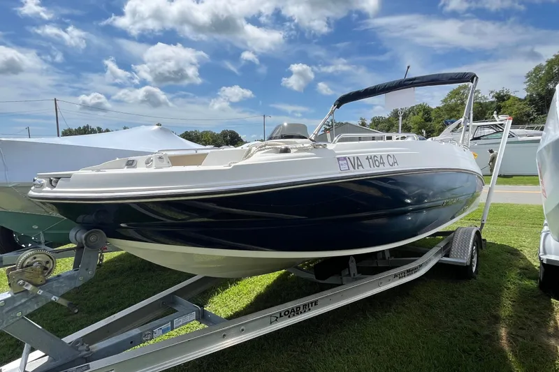 The Image of 2017 Stingray 192 SC boat on trailer under a partly cloudy sky. - 0