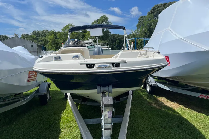 Slide: The Image of 2017 Stingray 192 SC boat on trailer, parked outdoors under blue sky. - 14