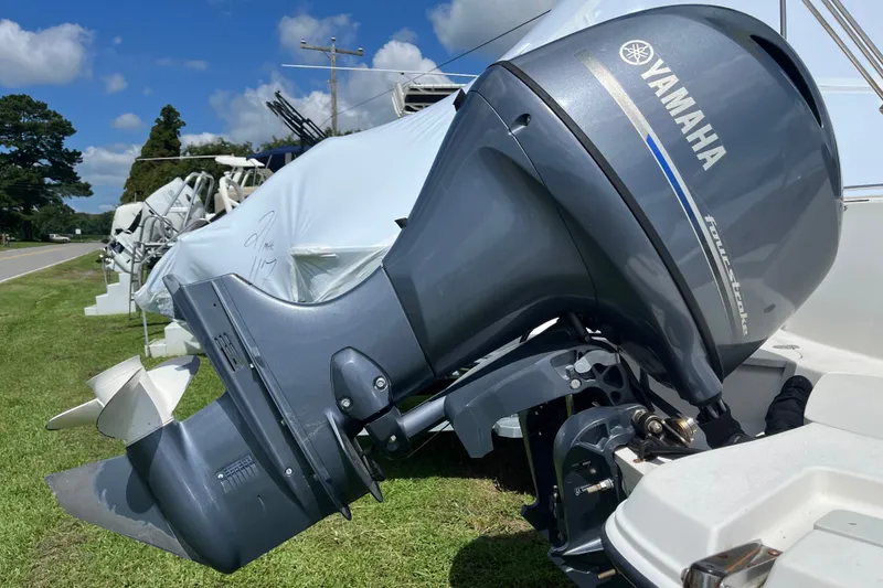 Slide: The Image of Yamaha outboard motor on a 2017 Stingray 192 SC boat, parked on grass. - 16