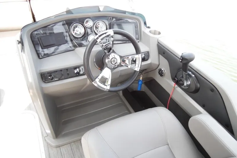 Slide: The Image of 2021 Avalon LSZ Quad Lounge 24' boat dashboard with steering wheel and controls. - 18