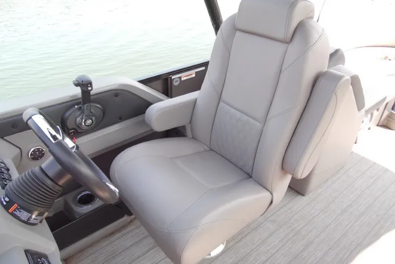 Slide: The Image of Captain's chair in 2021 Avalon LSZ Quad Lounge 24' boat, featuring sleek design and controls. - 17
