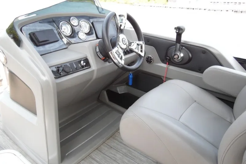 Slide: The Image of 2021 Avalon LSZ Quad Lounge 24' boat helm with steering wheel and controls. - 22