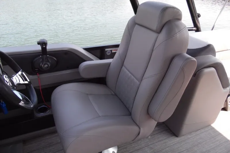 Slide: The Image of 2021 Avalon LSZ Quad Lounge 24' boat captain's chair with armrests and steering wheel. - 21