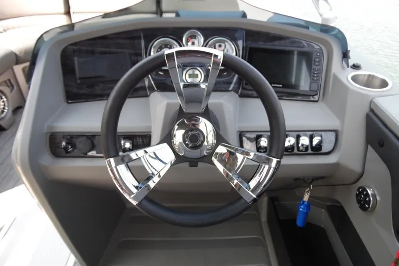 Slide: The Image of 2021 Avalon LSZ Quad Lounge 24' boat dashboard with steering wheel and controls. - 19
