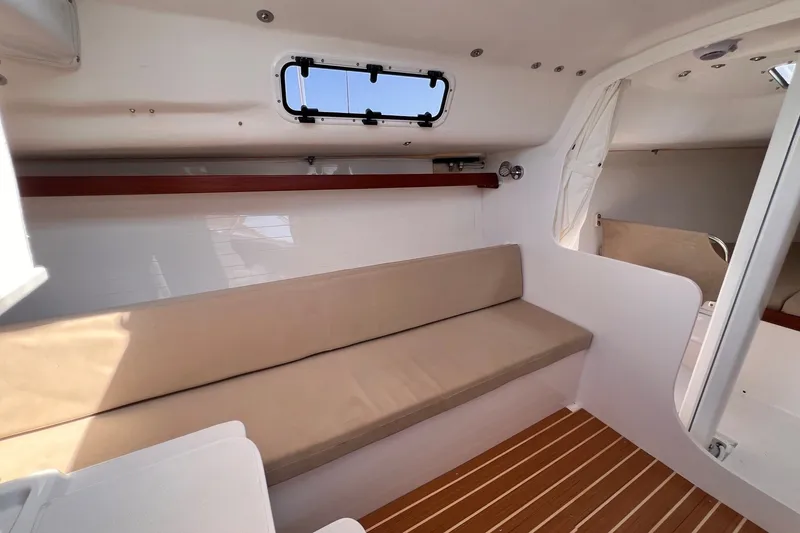 Slide: The Image of Interior of 2023 J Boats J/9 sailboat with beige seating and wooden flooring. - 30
