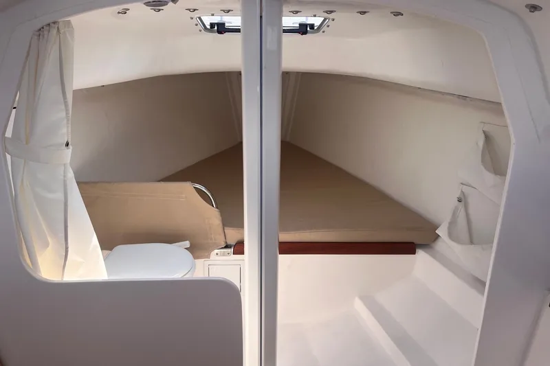 Slide: The Image of Interior cabin of 2023 J Boats J/9 sailboat, featuring a cozy sleeping area and compact toilet. - 35