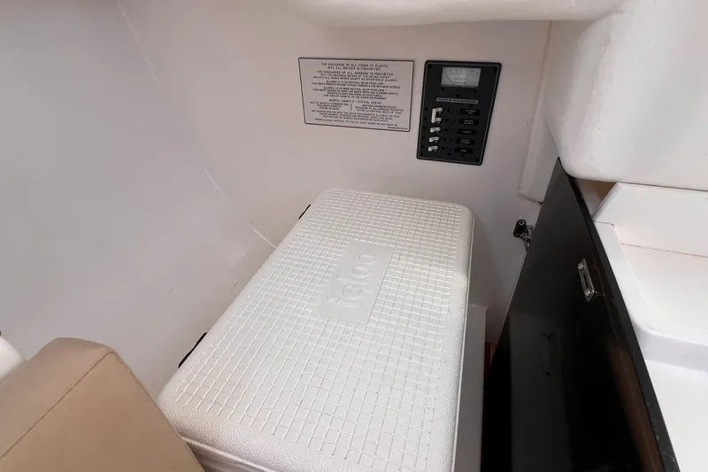 Slide: The Image of Interior of 2023 J Boats J/9 featuring a cooler and control panel. - 34