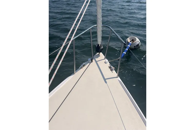 Slide: The Image of Bow of 2023 J Boats J/9 sailboat on water, with mooring buoy nearby. - 8