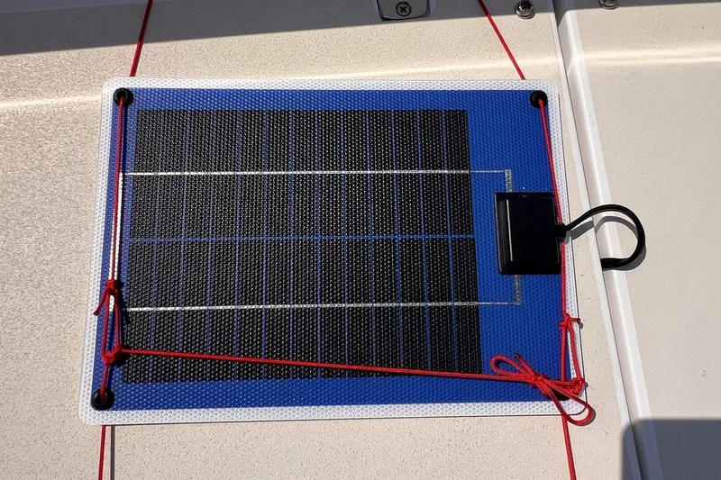 Slide: The Image of Solar panel on 2023 J Boats J/9, secured with red cords on deck. - 22