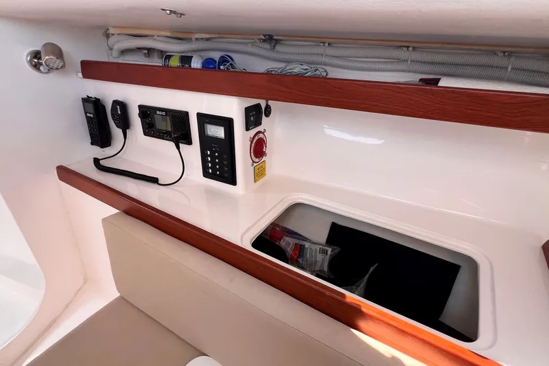 Slide: The Image of Interior view of 2023 J Boats J/9 sailboat with navigation equipment and storage compartment. - 32