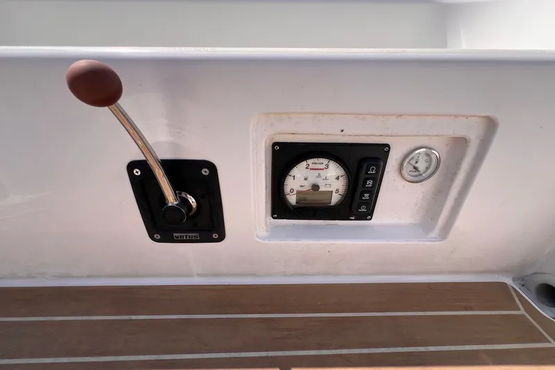 Slide: The Image of 2023 J Boats J/9 cockpit controls with throttle lever and instrument panel. - 23