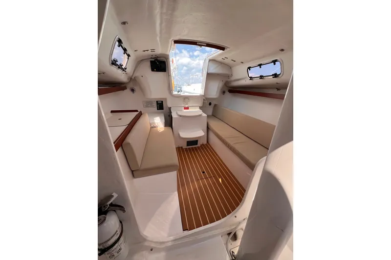 Slide: The Image of Interior of 2023 J Boats J/9 sailboat with seating and wooden flooring. - 29