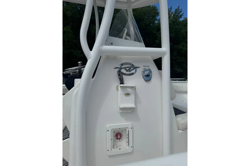 Slide: The Image of 2021 Tidewater 220 LXF boat console with steering wheel and controls. - 2