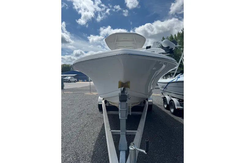 Slide: The Image of 2021 Tidewater 220 LXF boat on trailer under a partly cloudy sky. - 1